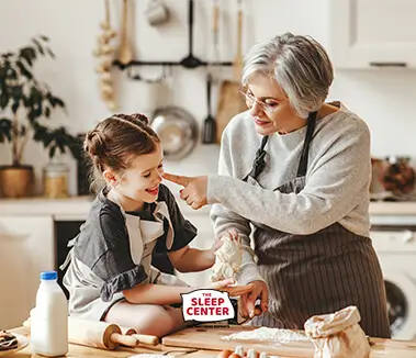 Grandma and grand child cooking and laughing